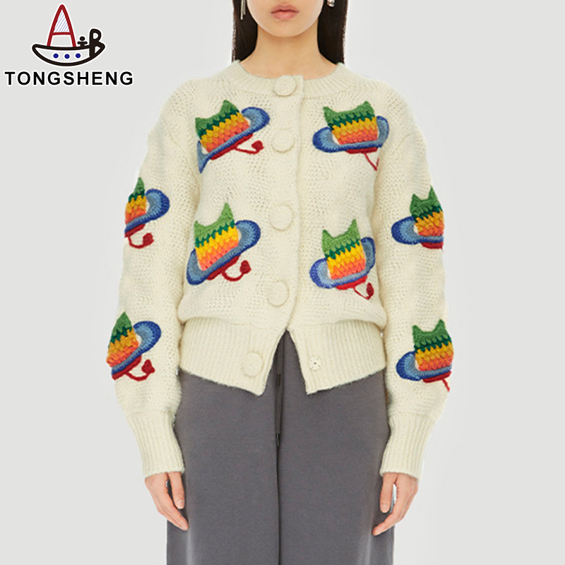 White cardigan with colorful owl embroidered on it
