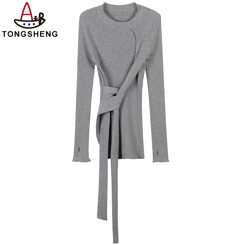 The grey knitted top has a unique design for a stylish look