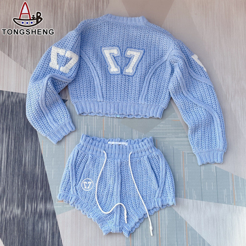 Blue cable knitted suit with white pattern on it, lively and cute