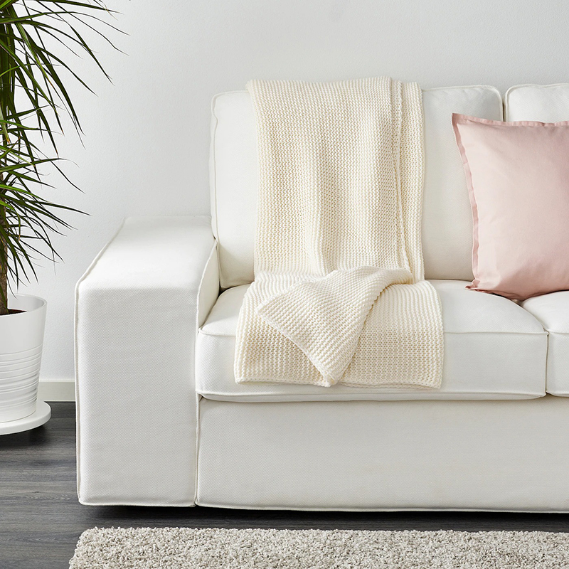 Organic cotton blanket hanging on sofa