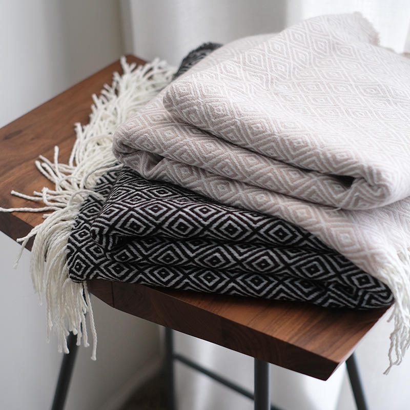 The patterned blanket with fringe comes in 2 colors