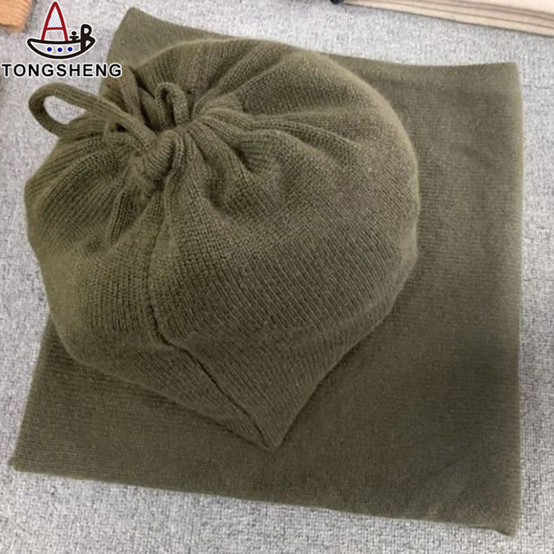 =The dark green cashmere blanket has a bag to hold it
